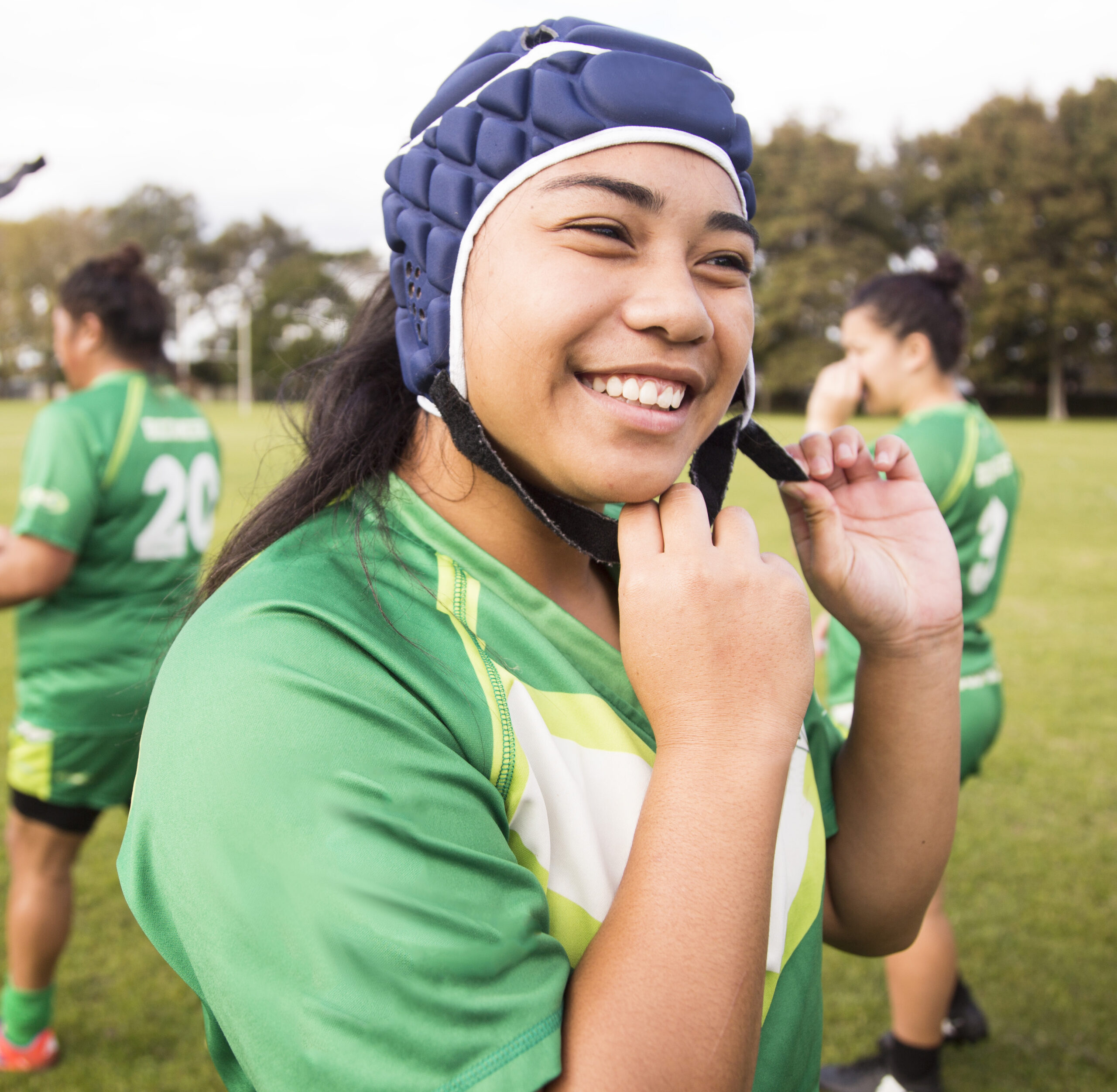Rugby league player smiling on a field
