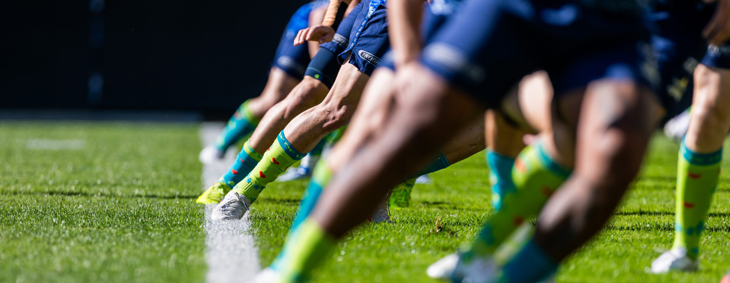 Rugby league players running on a field